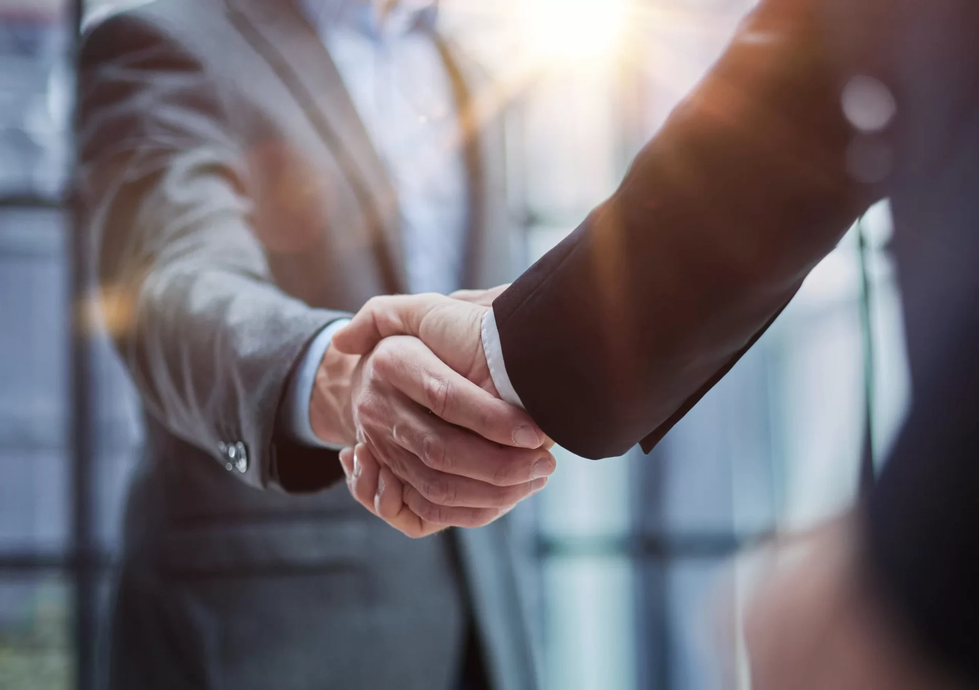 https://ob-techsolutions.com/wp-content/uploads/2024/10/two-diverse-professional-business-men-executive-leaders-shaking-hands-office-meeting-1-scaled-1.webp